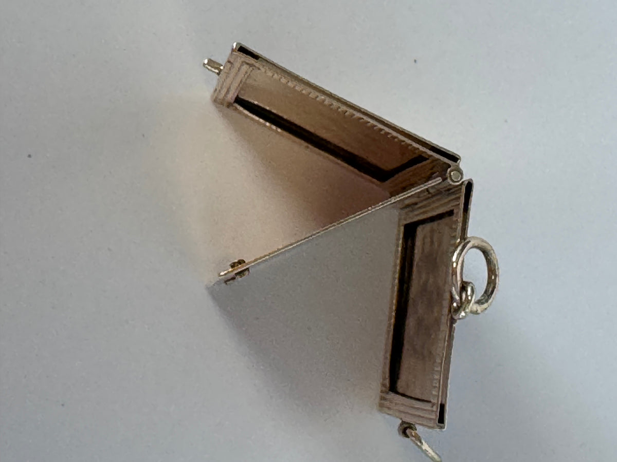 Vintage 14K gold book locket with hinged pages, engine-turned texture, engraved details, multiple photo compartments