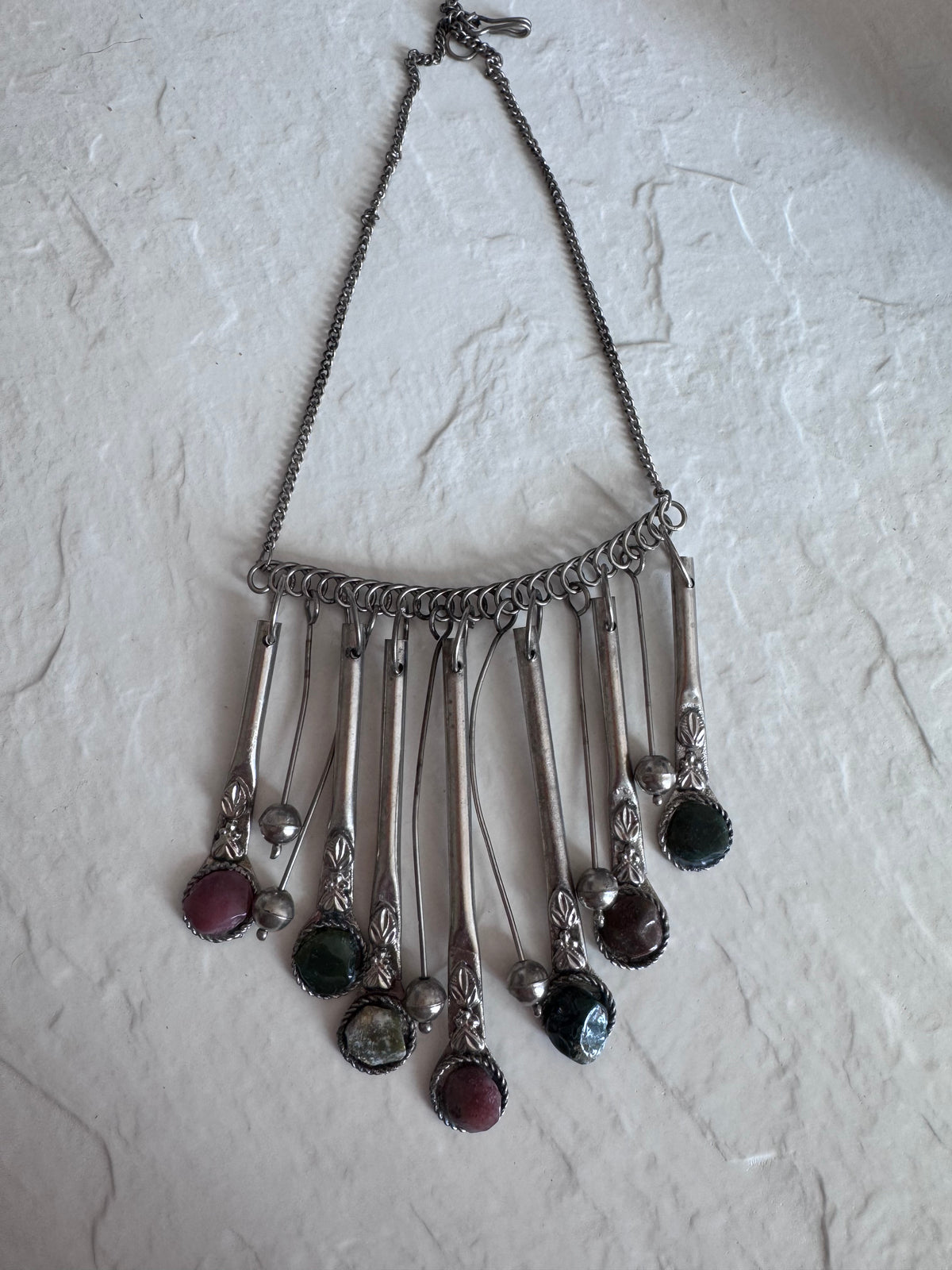 Estate vintage silver fringe necklace with multiple natural stones in purple green and brown tones showing bohemian statement jewelry design