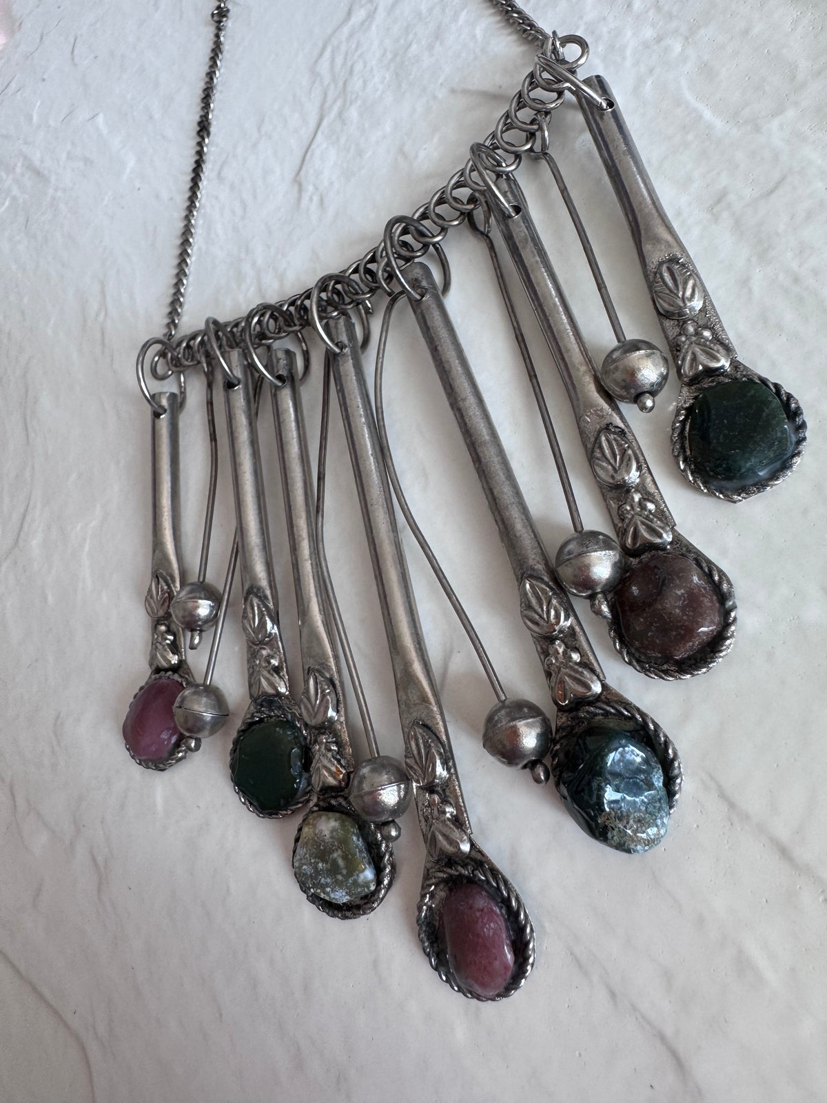 Estate vintage silver fringe necklace with multiple natural stones in purple green and brown tones showing bohemian statement jewelry design