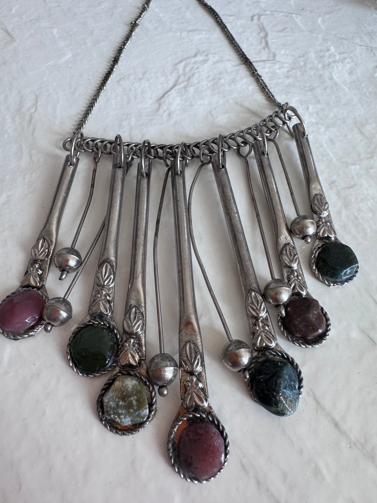 Estate vintage silver fringe necklace with multiple natural stones in purple green and brown tones showing bohemian statement jewelry design