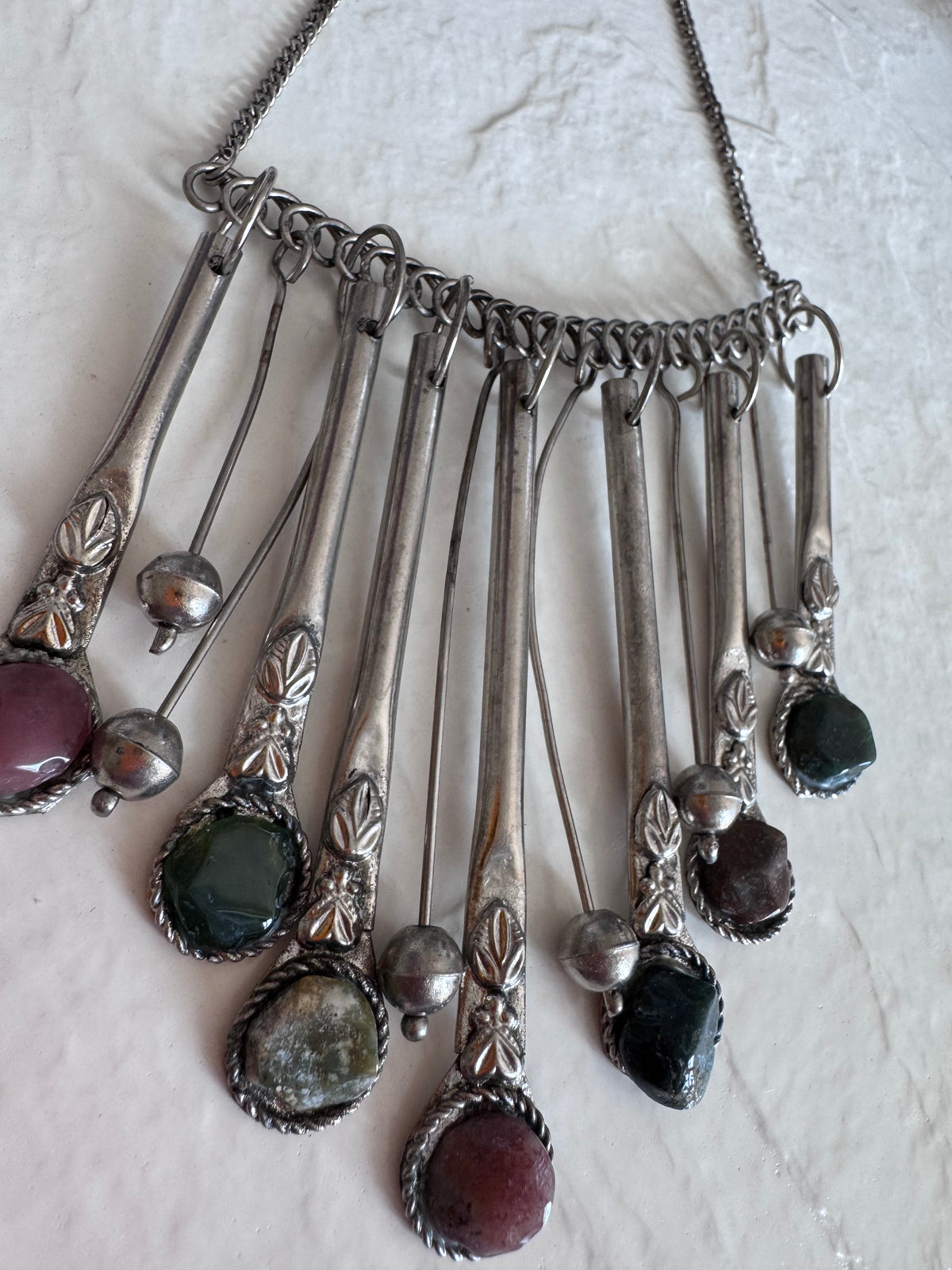 Estate vintage silver fringe necklace with multiple natural stones in purple green and brown tones showing bohemian statement jewelry design