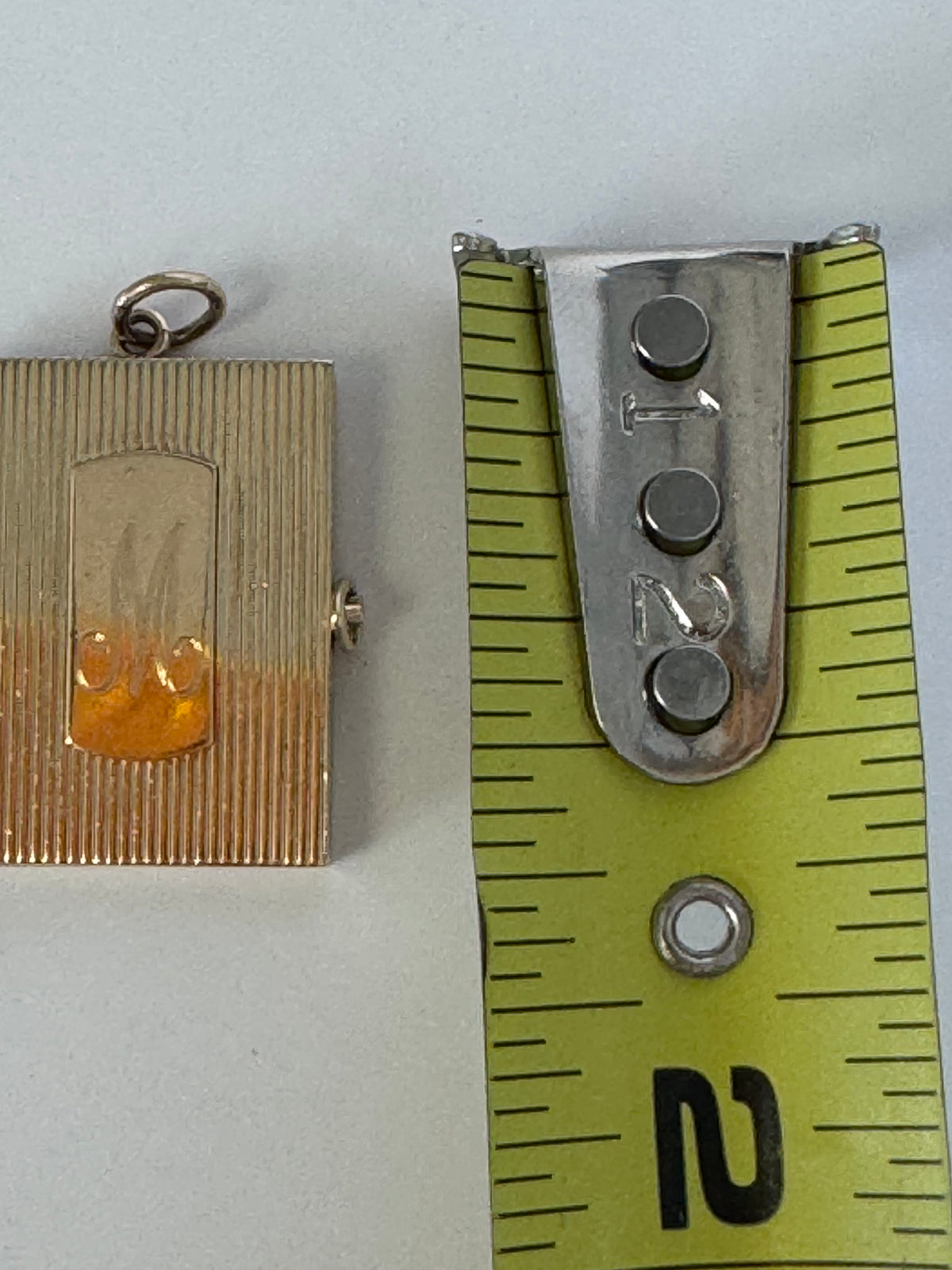 Vintage 14K gold book locket with hinged pages, engine-turned texture, engraved details, multiple photo compartments