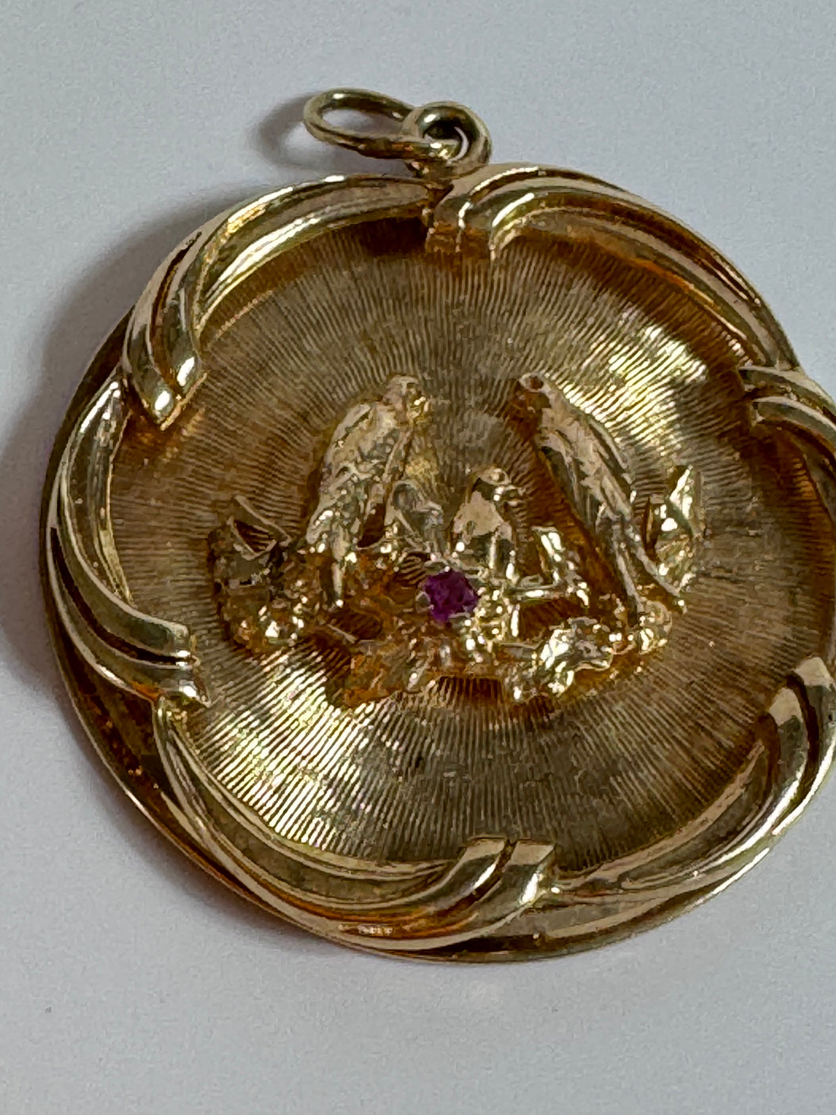 1950s 14K gold love birds medallion pendant with engine turned background and ruby accent, vintage romantic jewelry