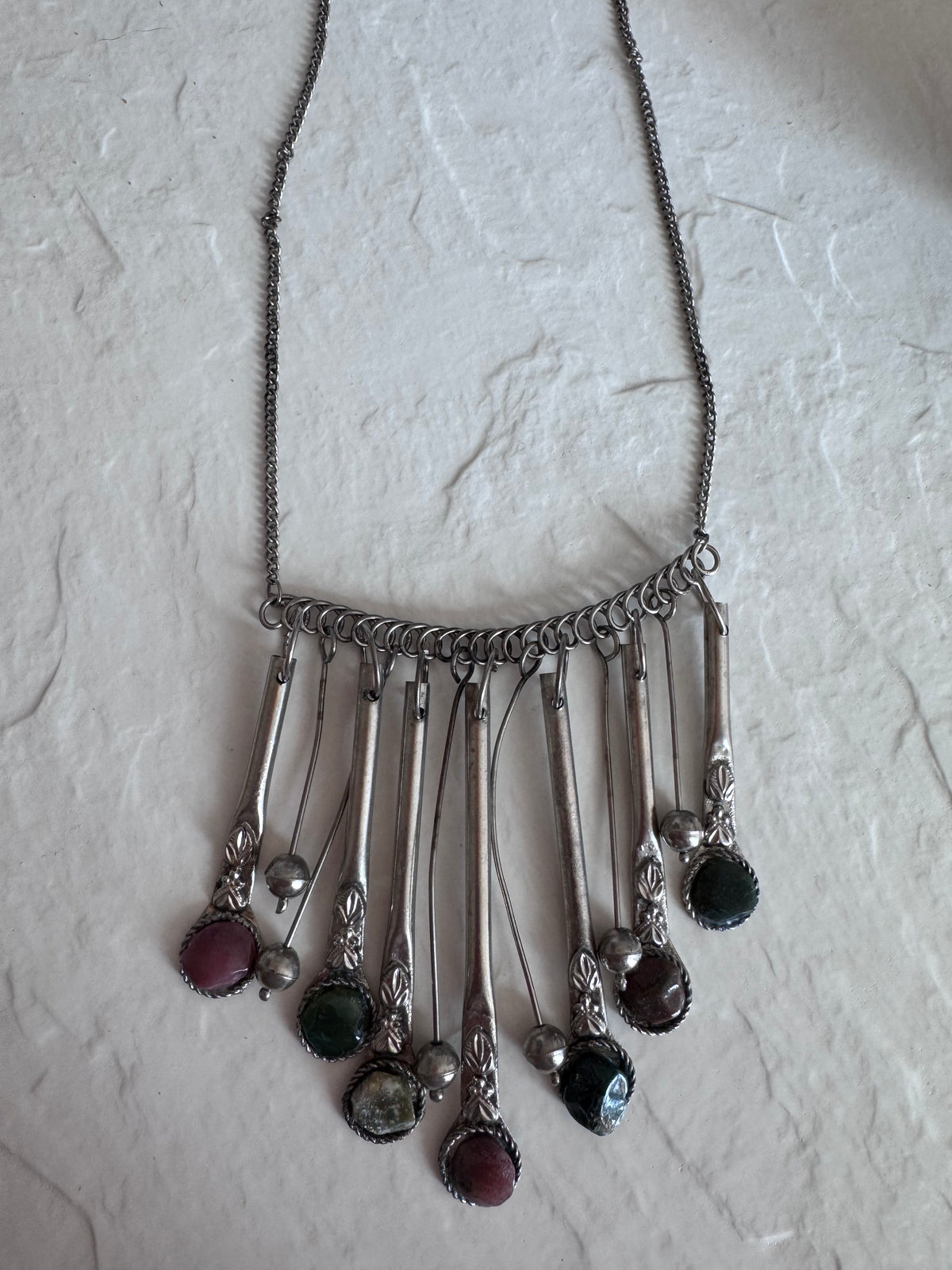 Estate vintage silver fringe necklace with multiple natural stones in purple green and brown tones showing bohemian statement jewelry design