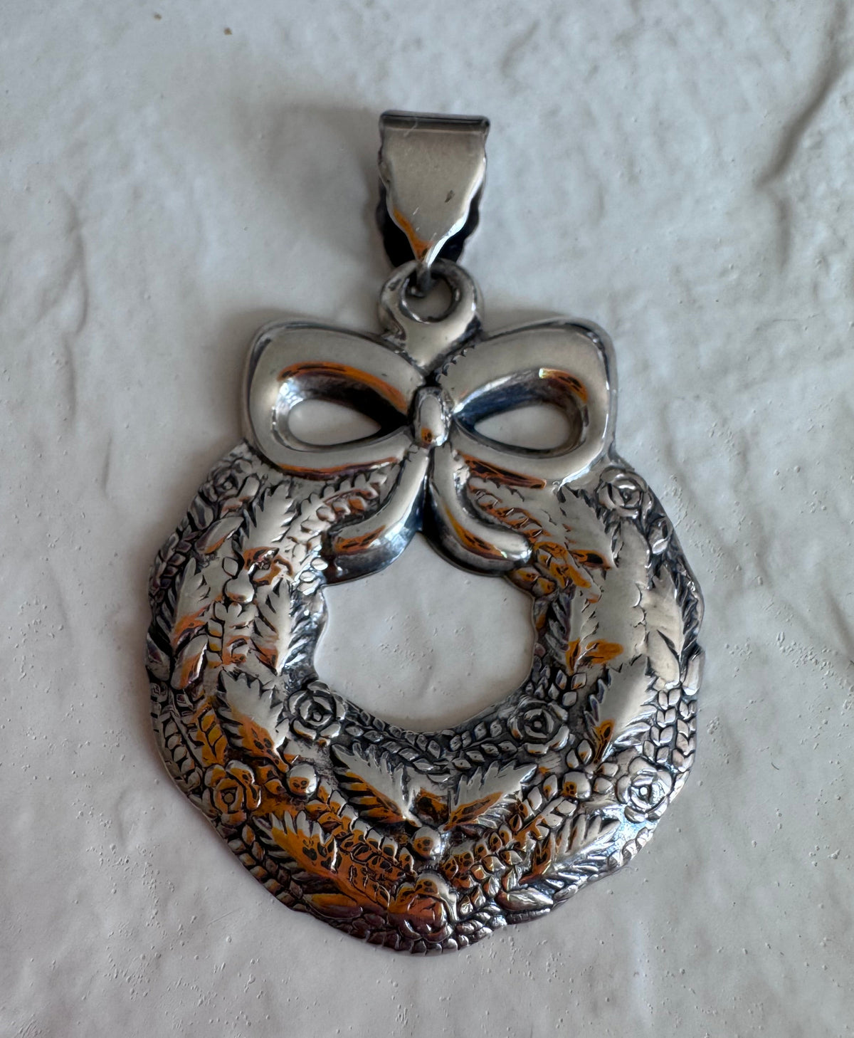 Estate 925 sterling silver Christmas wreath pendant from Thailand with detailed roses leaves and bow showing intricate Thai craftsmanship