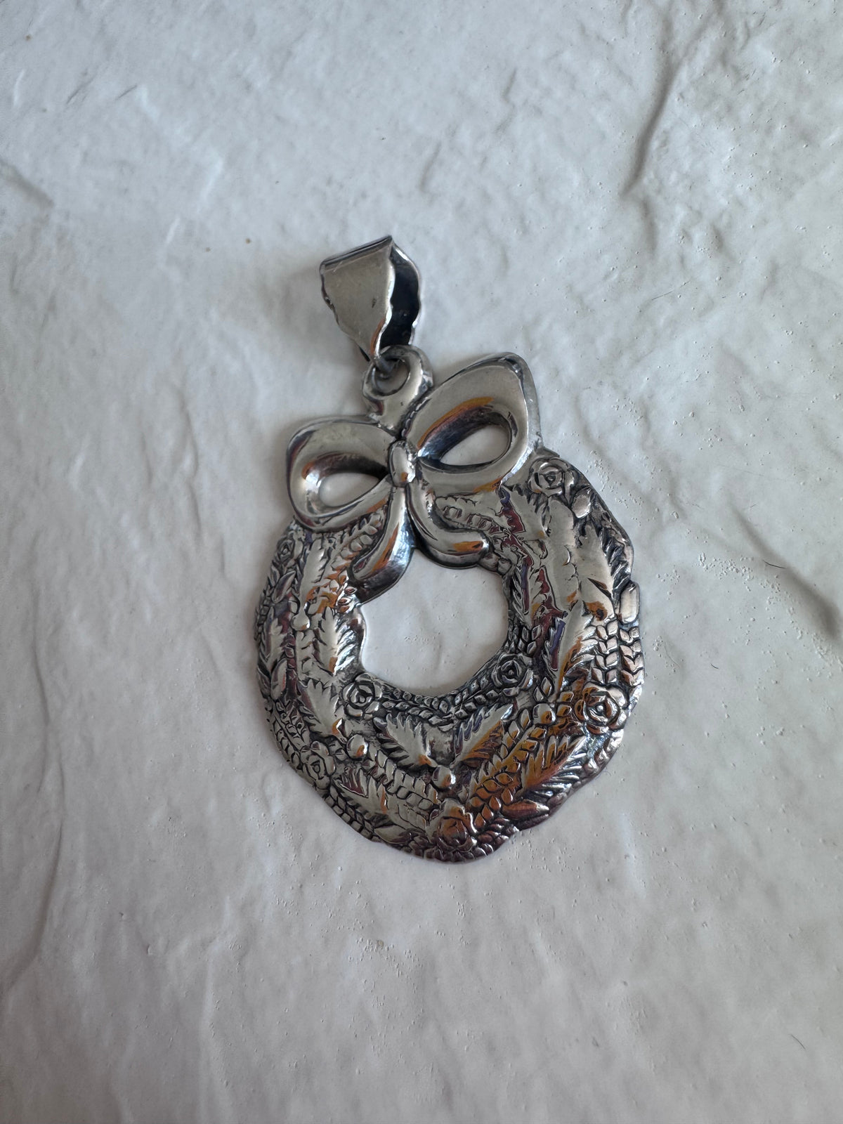 Estate 925 sterling silver Christmas wreath pendant from Thailand with detailed roses leaves and bow showing intricate Thai craftsmanship