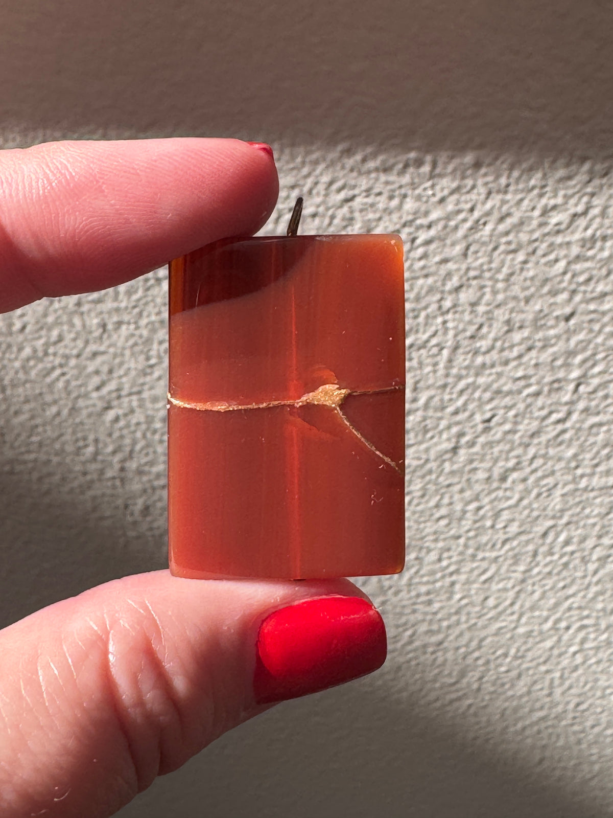Estate 14K gold pendant featuring natural red carnelian rectangle with dramatic gold strike mineral inclusions embodying wabi sabi aesthetics