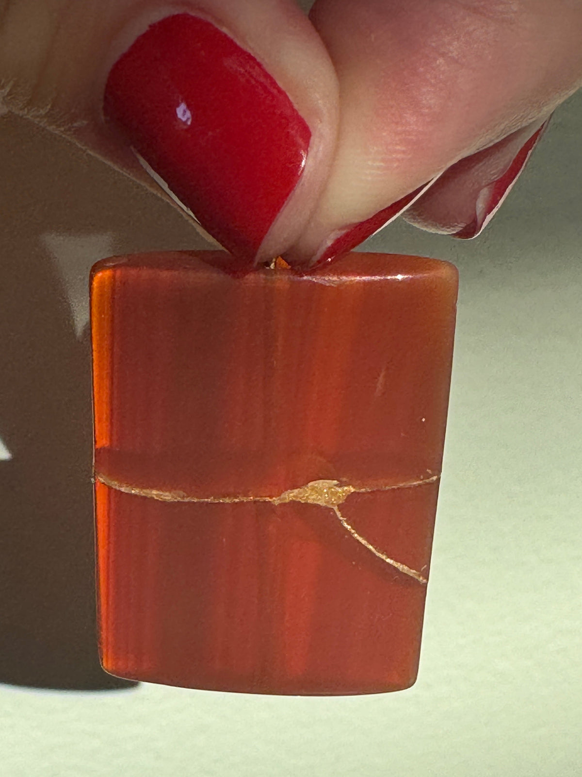 Estate 14K gold pendant featuring natural red carnelian rectangle with dramatic gold strike mineral inclusions embodying wabi sabi aesthetics