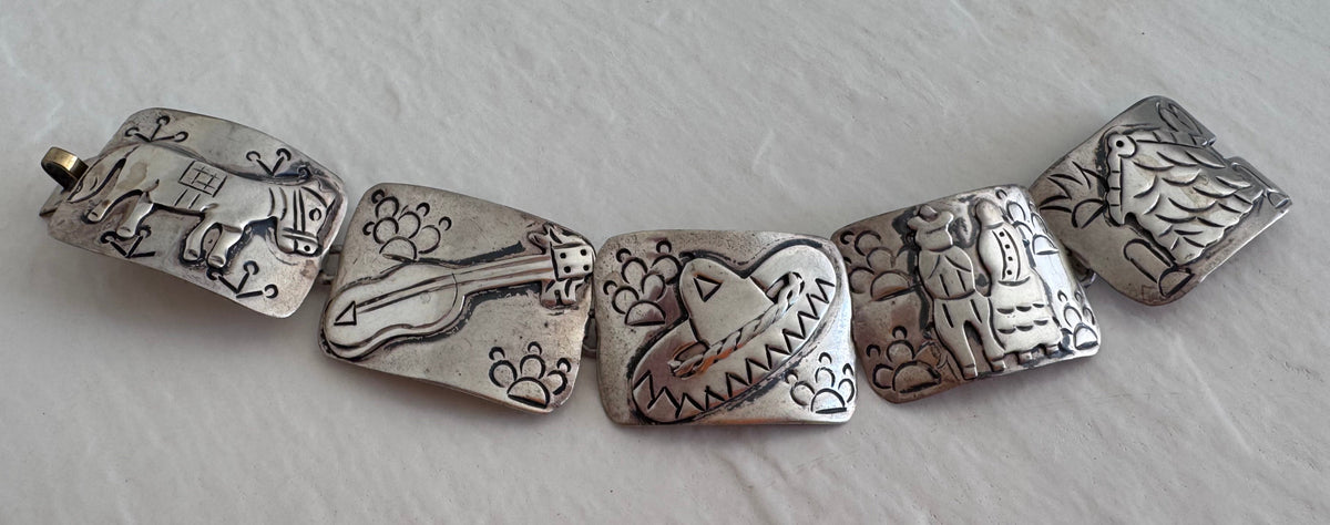 Estate J. Alvarez Taxco Mexican sterling silver storyteller panel bracelet showing detailed cultural scenes with guitar player, pottery, and folk motifs