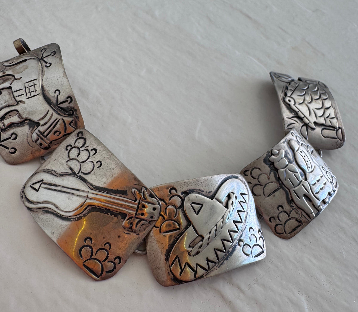 Estate J. Alvarez Taxco Mexican sterling silver storyteller panel bracelet showing detailed cultural scenes with guitar player, pottery, and folk motifs