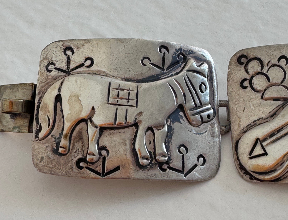 Estate J. Alvarez Taxco Mexican sterling silver storyteller panel bracelet showing detailed cultural scenes with guitar player, pottery, and folk motifs