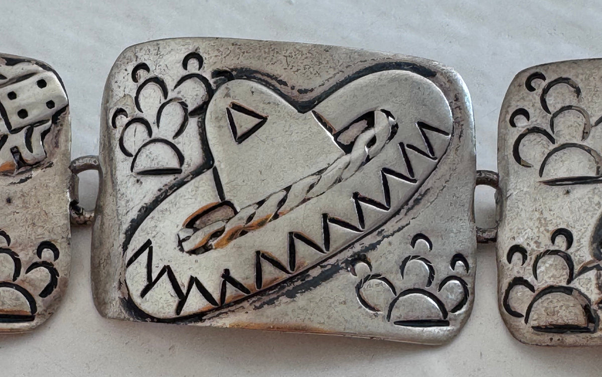 Estate J. Alvarez Taxco Mexican sterling silver storyteller panel bracelet showing detailed cultural scenes with guitar player, pottery, and folk motifs