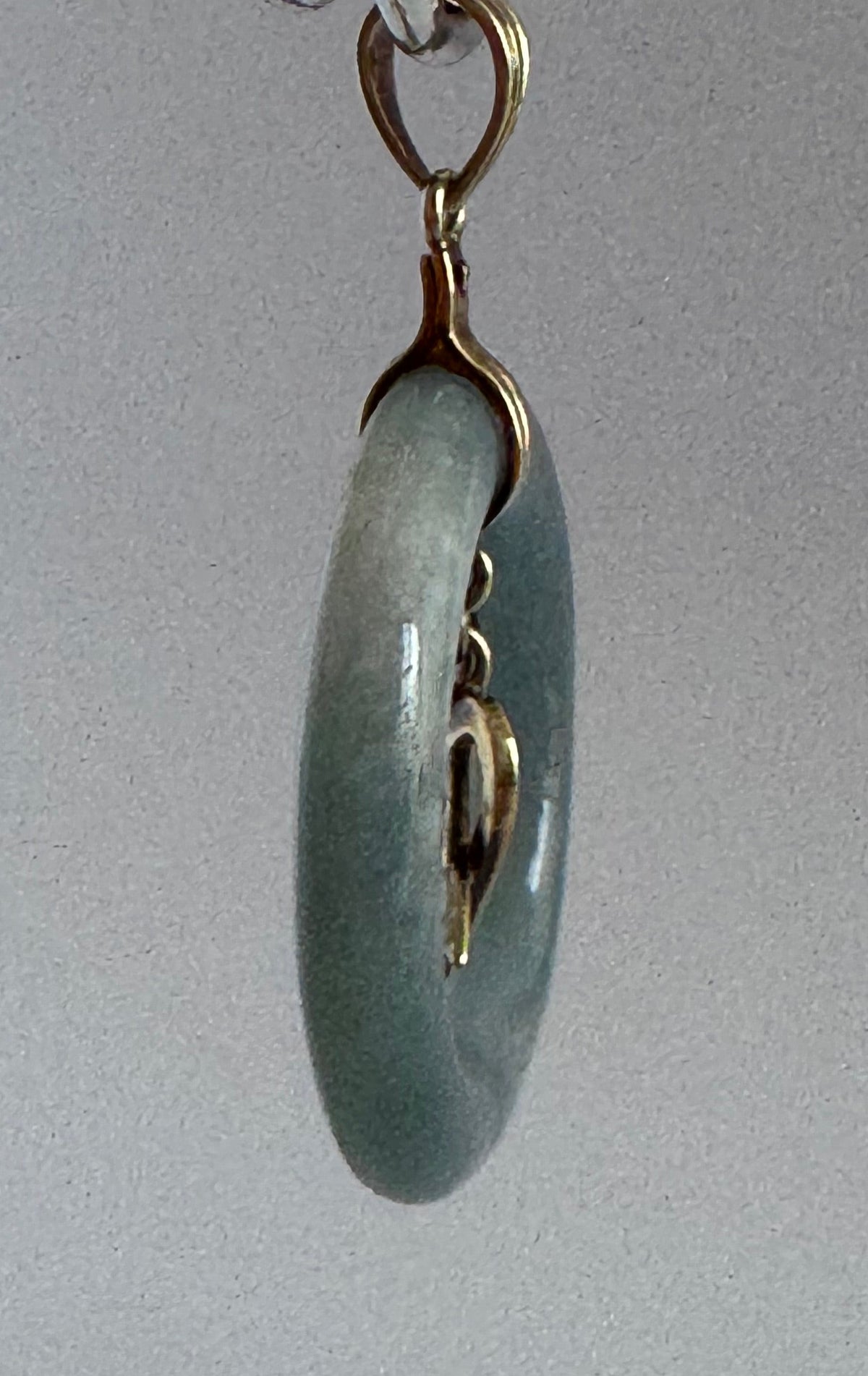 Estate vintage 14K yellow gold blue jadeite circle pendant with heart and arrow motif, showing translucent stone and quality gold framework