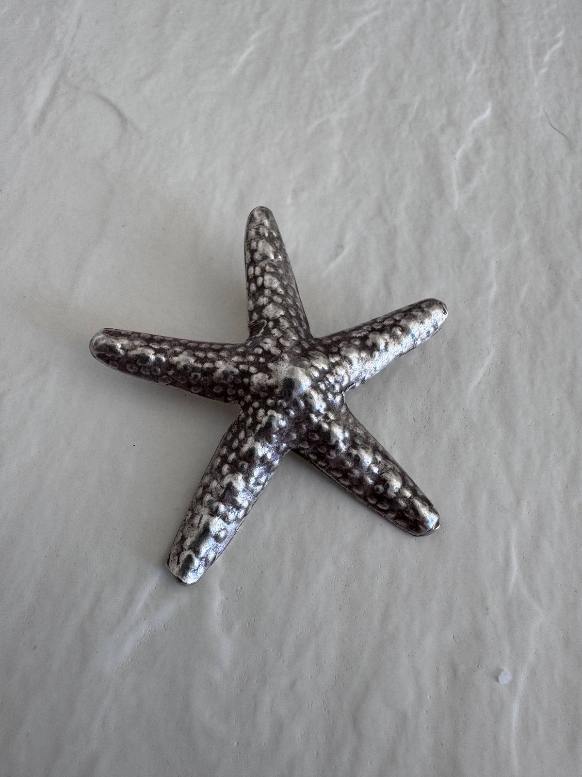 Large Karen Hill Tribe silver starfish pendants with textured surface showing authentic handcrafted details and hidden bail construction