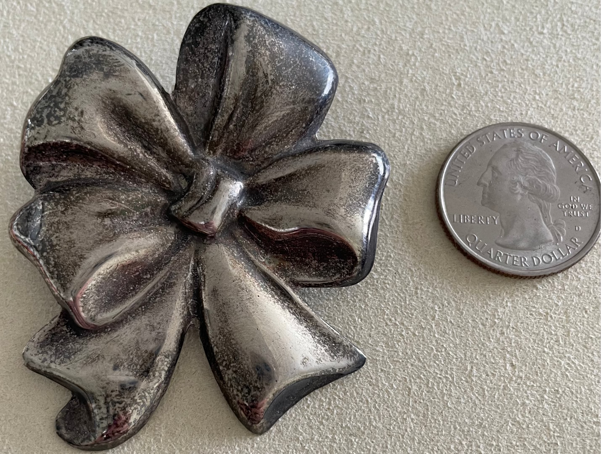 Large estate Mexican sterling silver puffy bow brooch pin pendant with mirror finish, displayed on pink cord necklace