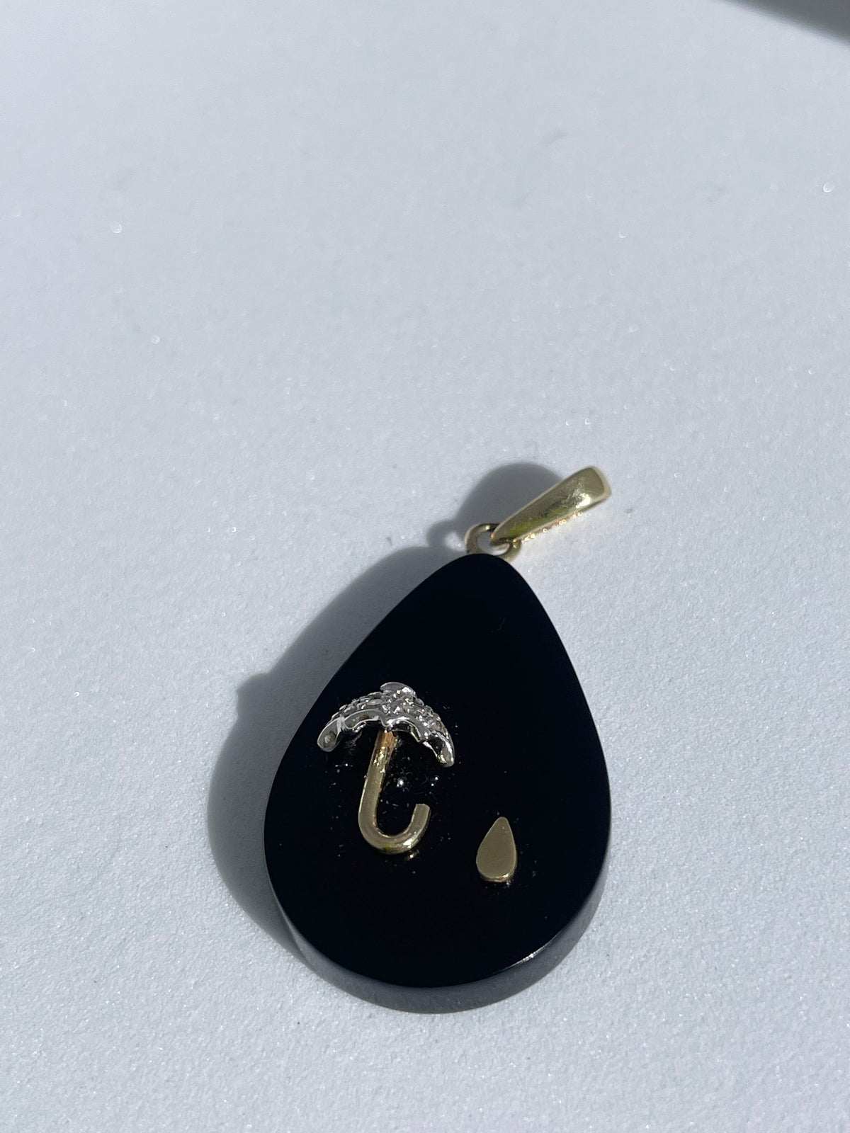 Estate 14K gold black onyx teardrop pendant with inlaid umbrella and raindrop design, diamond accent, 1980s whimsical jewelry
