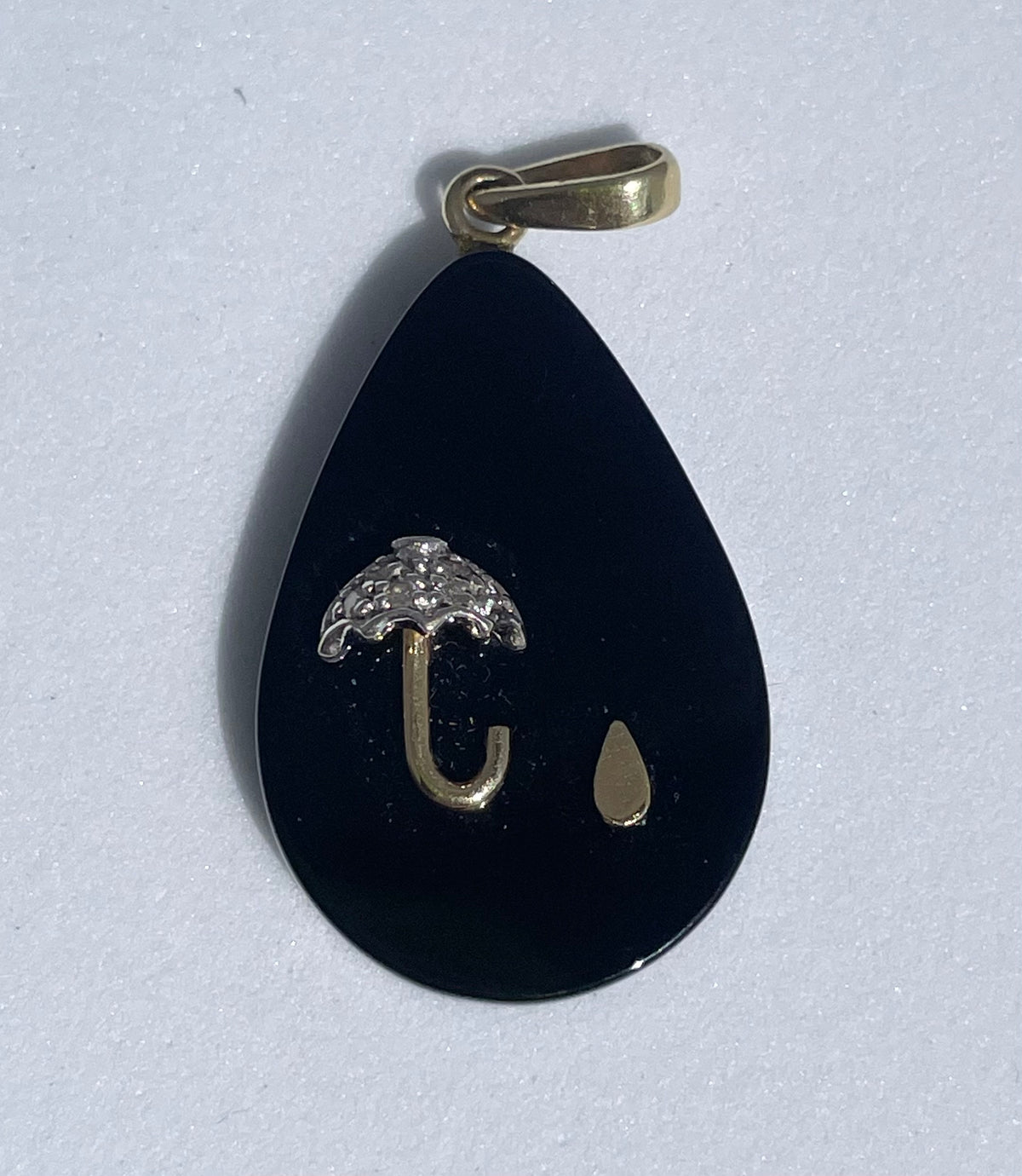 Estate 14K gold black onyx teardrop pendant with inlaid umbrella and raindrop design, diamond accent, 1980s whimsical jewelry