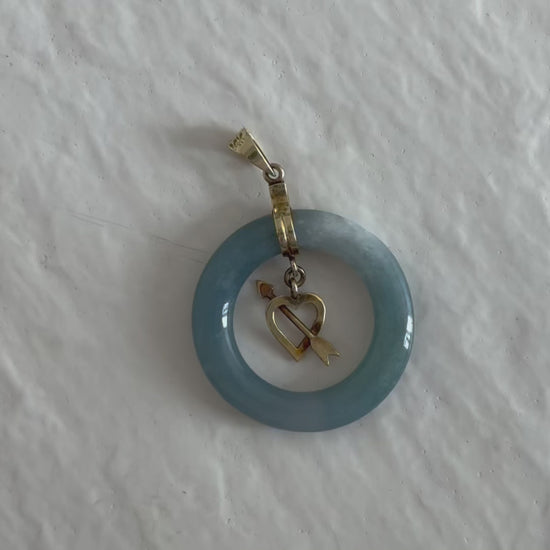 Estate vintage 14K yellow gold blue jadeite circle pendant with heart and arrow motif, showing translucent stone and quality gold framework