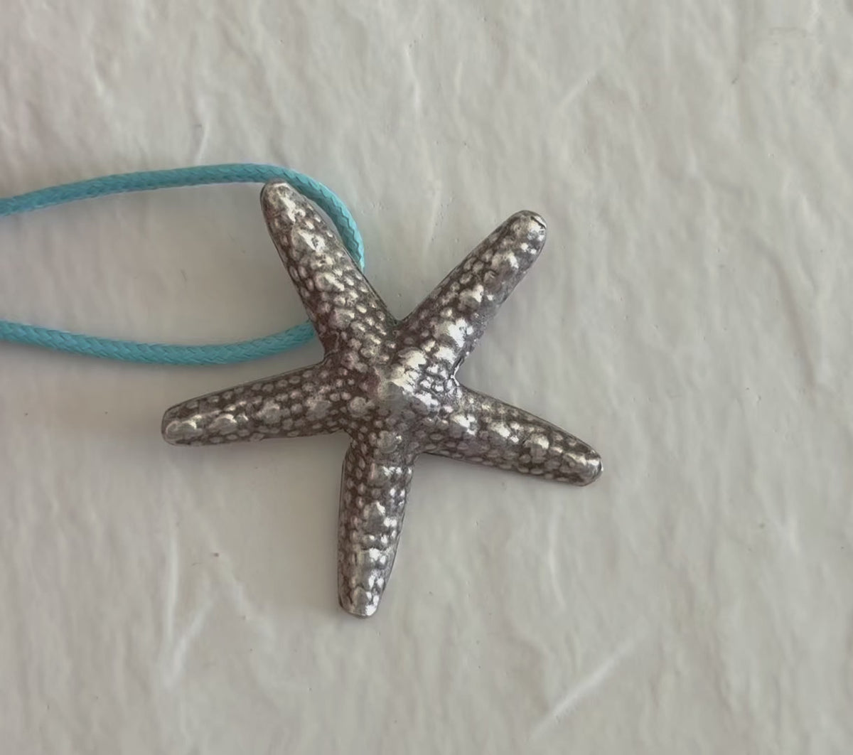 Large Karen Hill Tribe silver starfish pendants with textured surface showing authentic handcrafted details and hidden bail construction